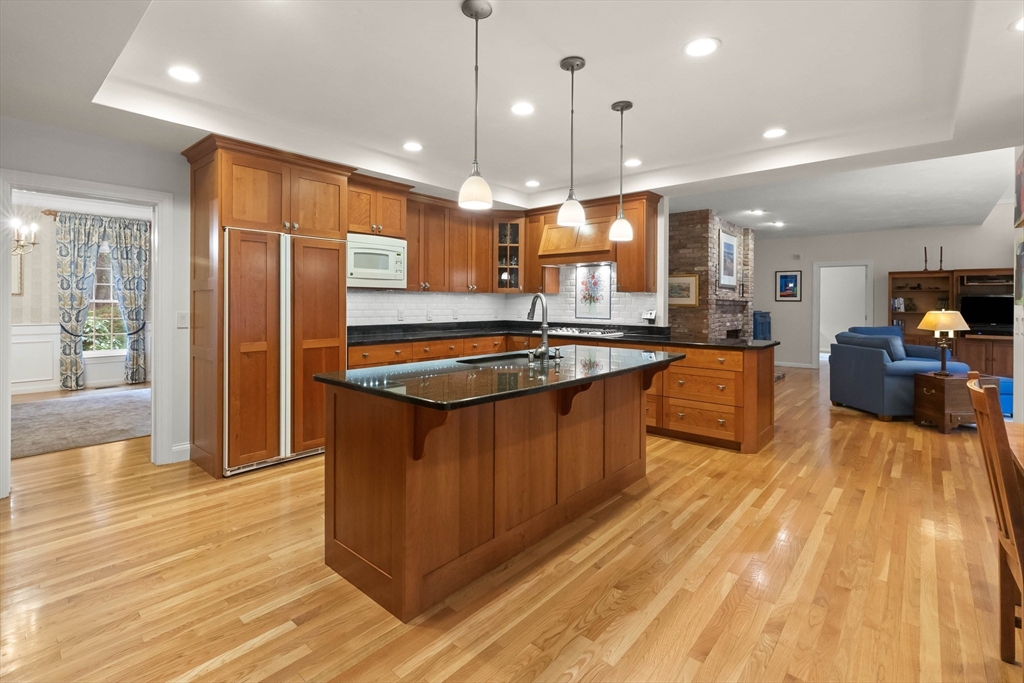 3 Woodland Road Boxford, MA 01921 - Photo 25 of 37 a kitchen with stainless steel appliances granite countertop a sink a stove and a refrigerator