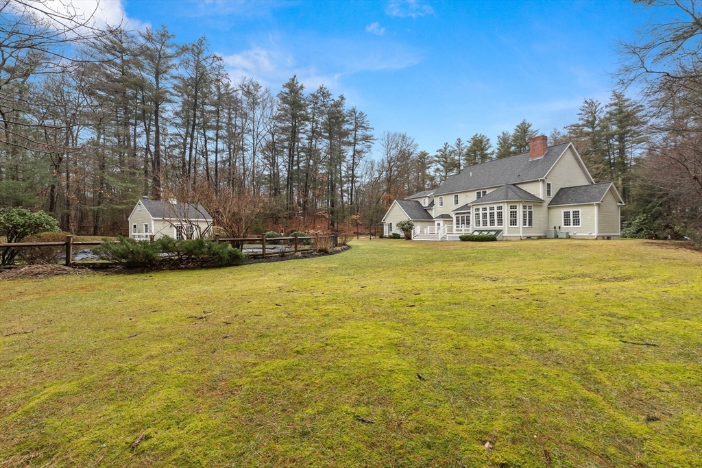 3 Woodland Road Boxford, MA 01921 - Photo 7 of 37 a view of a swimming pool with an outdoor space and seating area