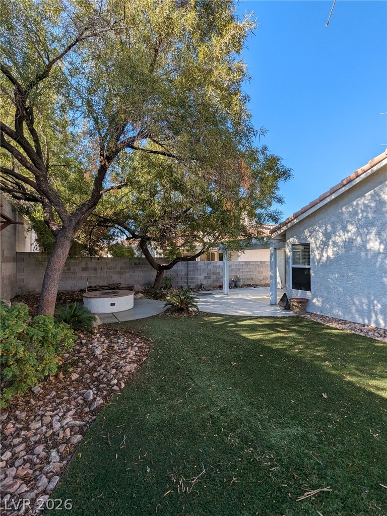 2407 Worchester Road Henderson, NV 89074 - Photo 4 of 5 A private yard with mature trees offers a serene outdoor retreat.