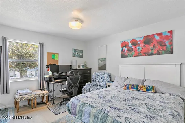 a bedroom that has a bed and a desk in it