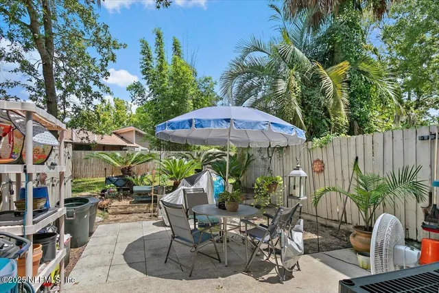 an outdoor space with furniture and umbrella