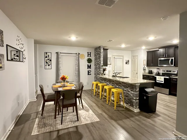a kitchen with stainless steel appliances kitchen island granite countertop a sink and cabinets