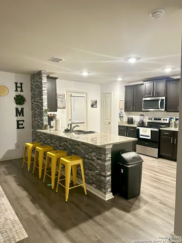 a large kitchen with stainless steel appliances lots of counter top space