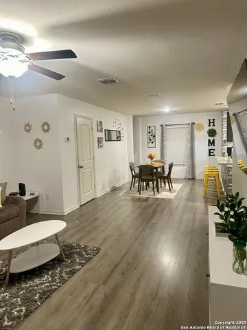 a living room with furniture and wooden floor