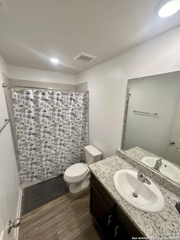 a bathroom with a sink toilet and shower