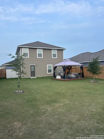 a front view of house with a garden