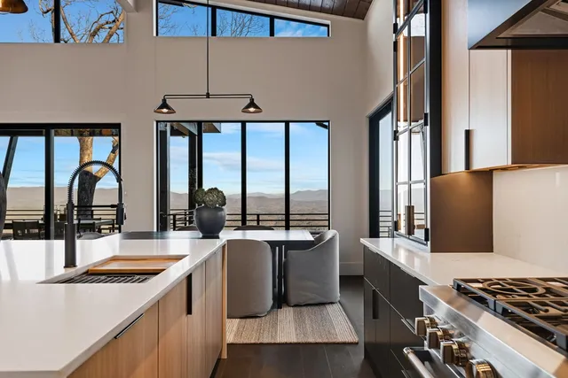 a kitchen with a table chairs refrigerator and cabinets