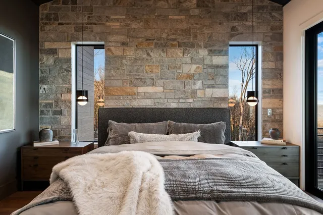 a roof deck with couches and potted plants