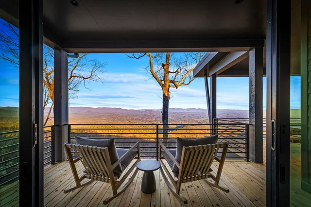 a bedroom with a bed a chair and potted plant on it