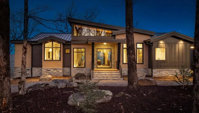 a living room with furniture a fireplace and a chandelier