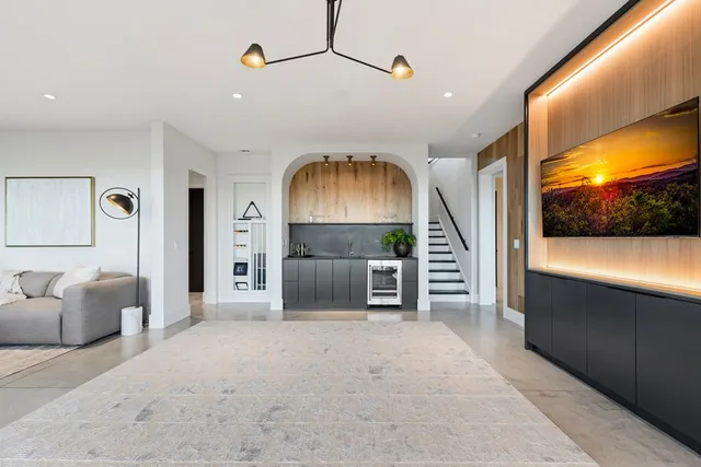 a living room with furniture potted plant and a fireplace