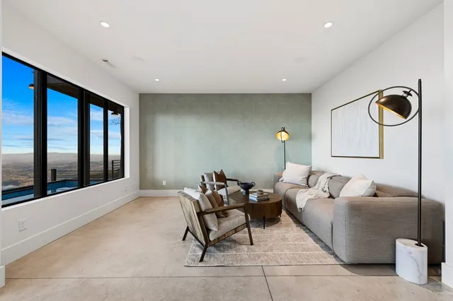 a view of a porch with a table and chairs