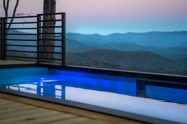 a living room with furniture a fireplace and a large window