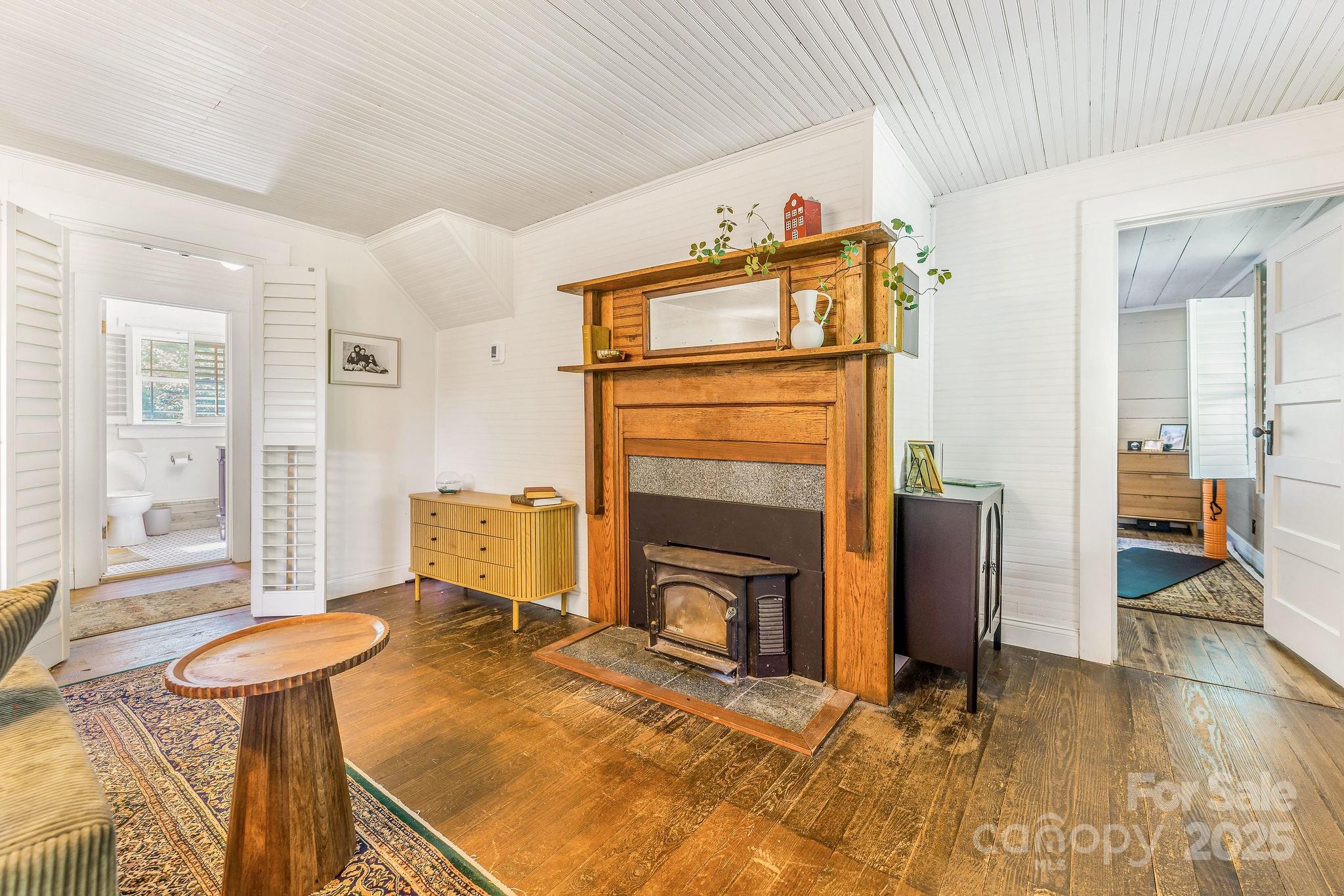 71 Persimmon Lane Canton, NC 28716 - Photo 11 of 25 a living room with furniture a flat screen tv and a fireplace