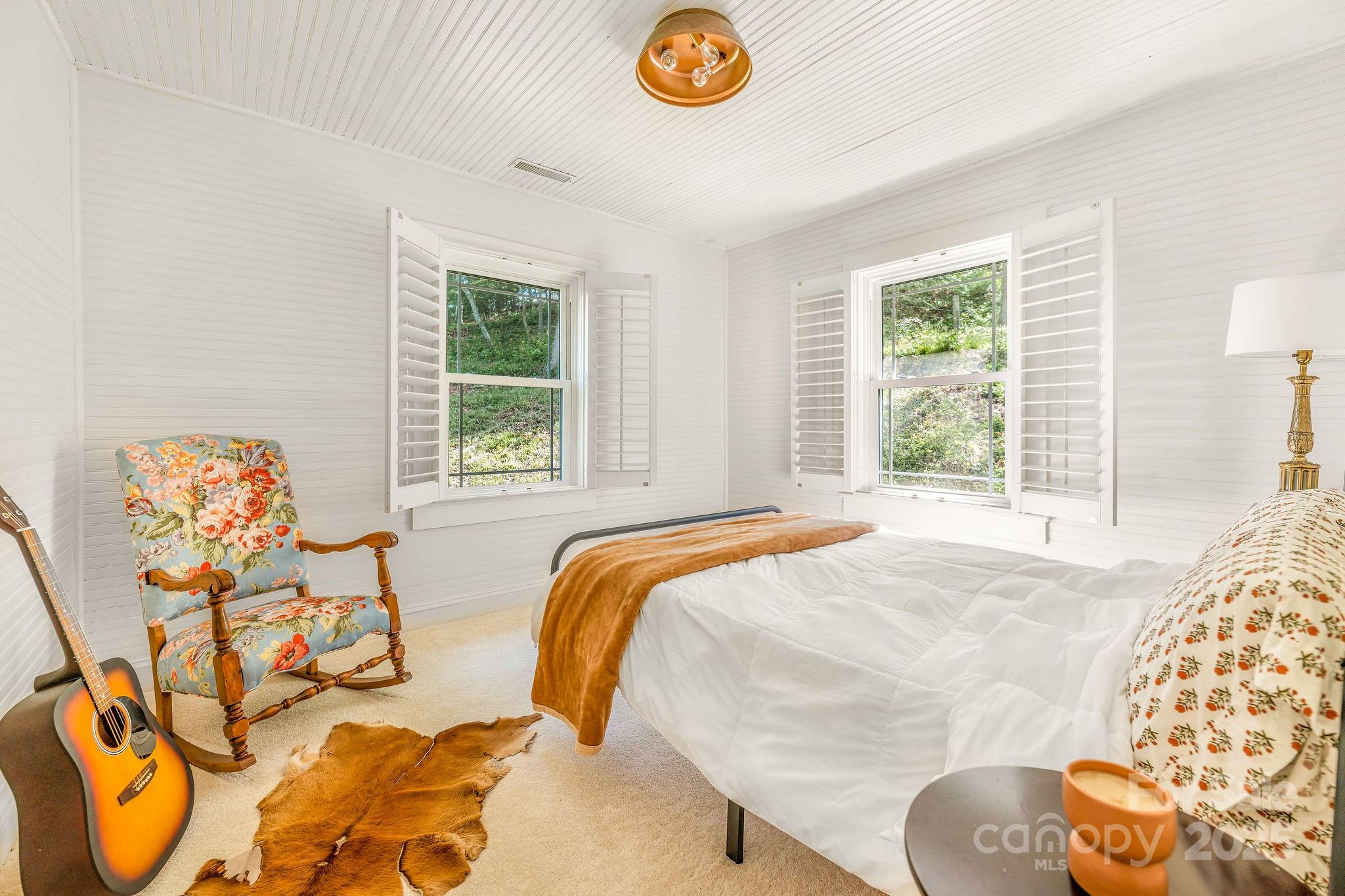 71 Persimmon Lane Canton, NC 28716 - Photo 12 of 25 a bed sitting in a bedroom next to a window