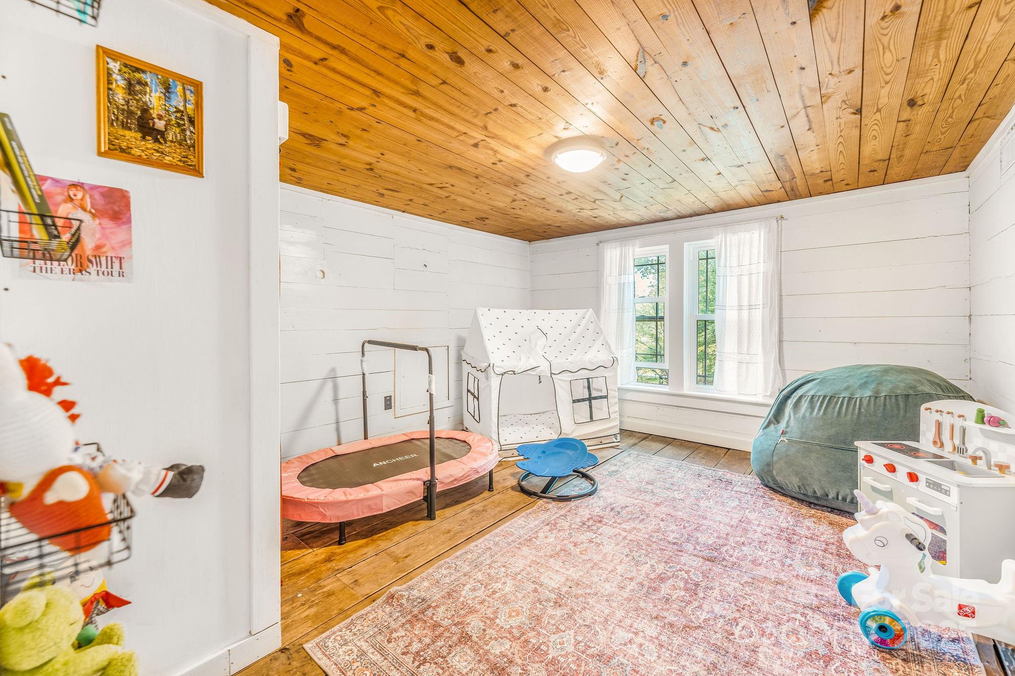 71 Persimmon Lane Canton, NC 28716 - Photo 15 of 25 a spacious bedroom with a bed and a window