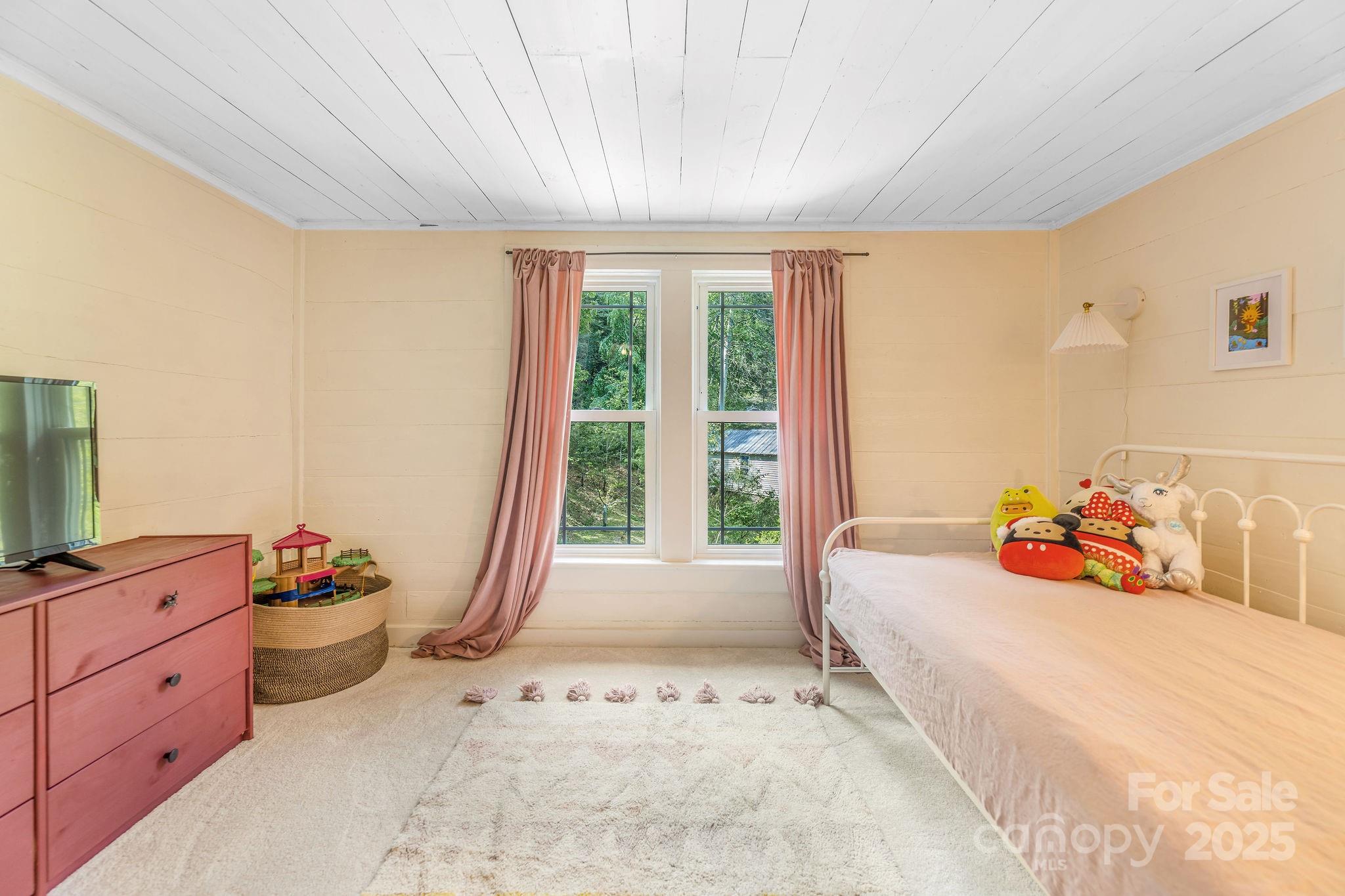 71 Persimmon Lane Canton, NC 28716 - Photo 18 of 25 a bedroom with a bed and large windows