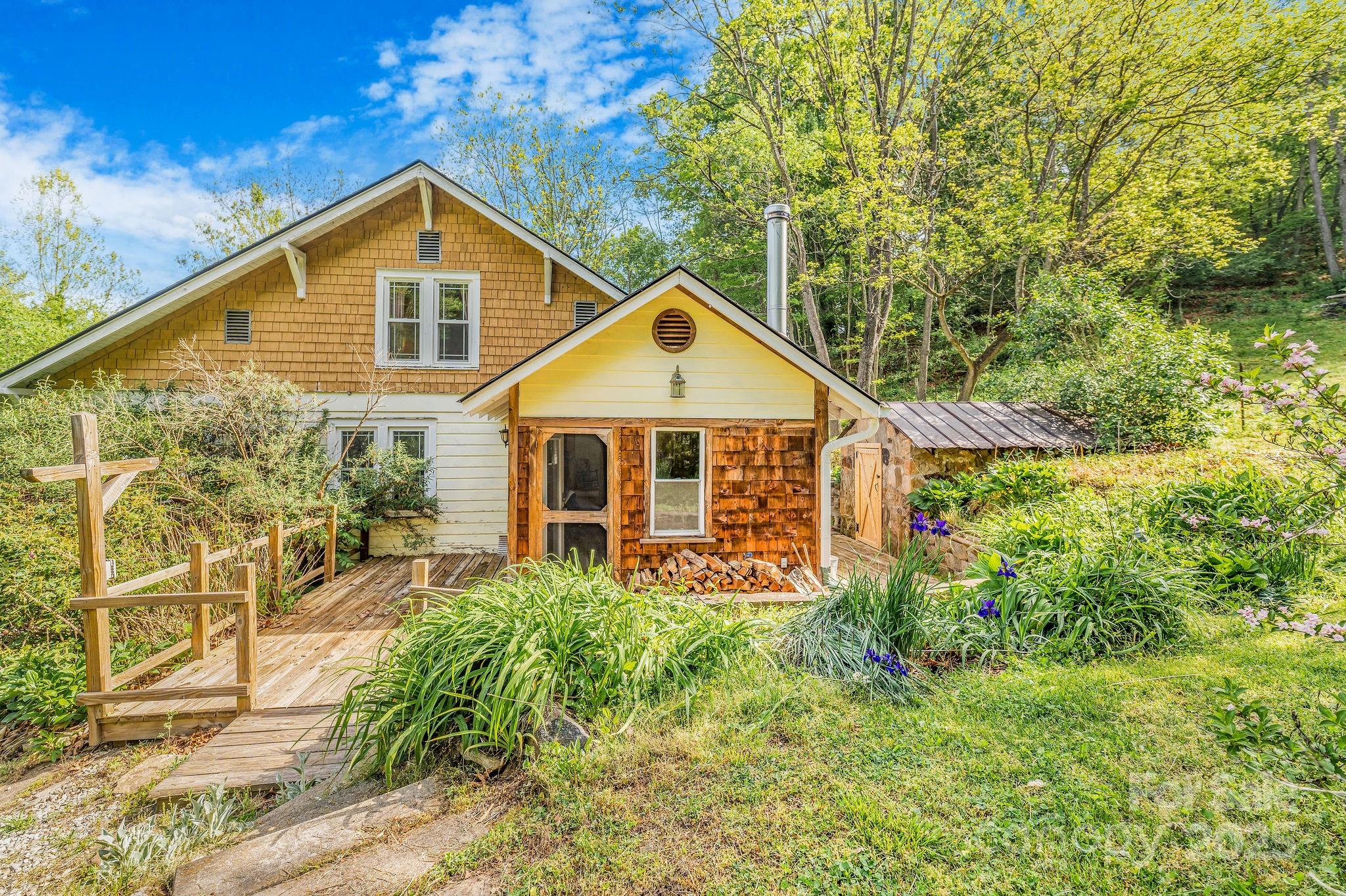 71 Persimmon Lane Canton, NC 28716 - Photo 3 of 25 a front view of a house with garden
