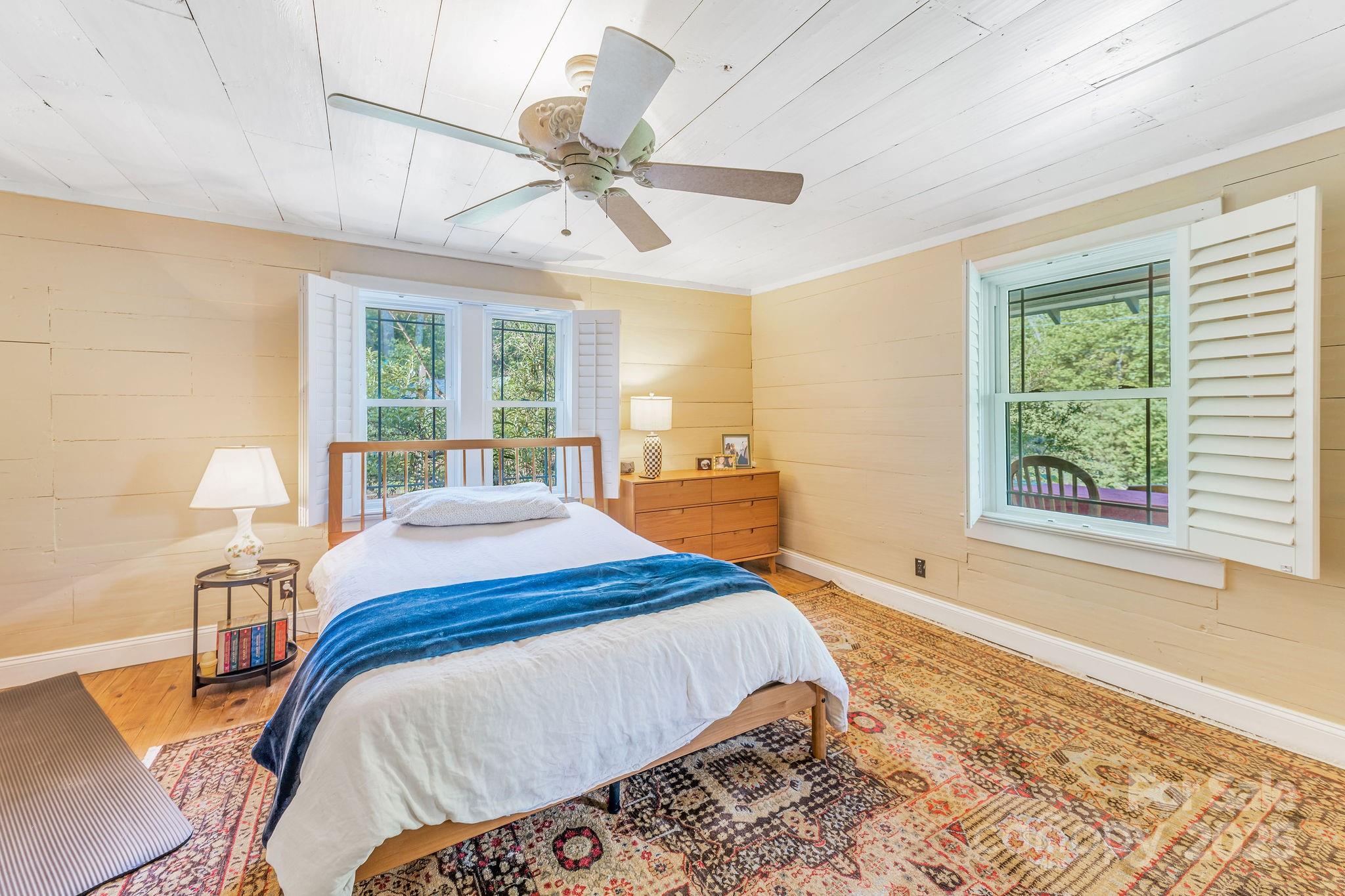 71 Persimmon Lane Canton, NC 28716 - Photo 7 of 25 a bed sitting in a bedroom next to a window