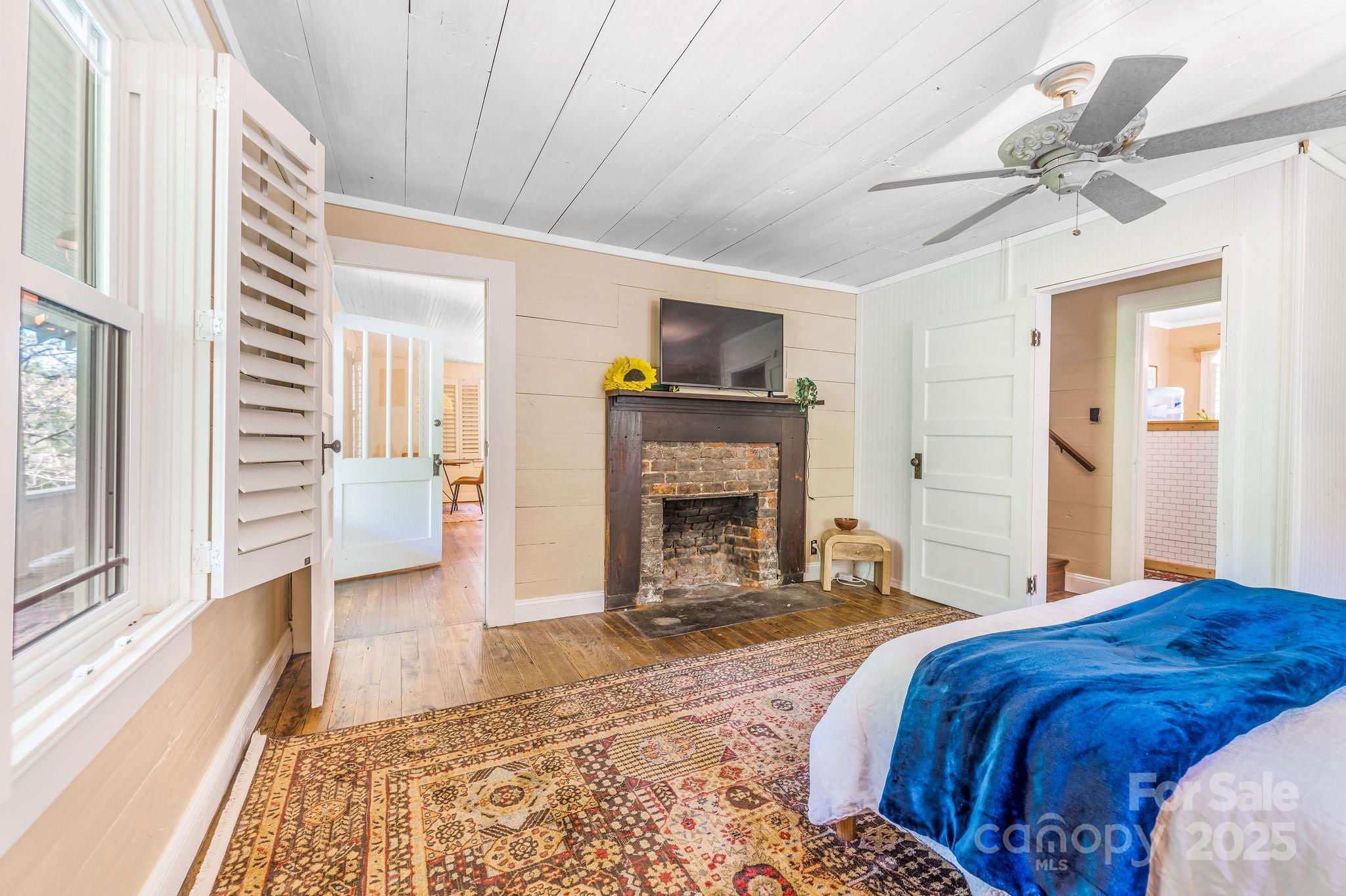 71 Persimmon Lane Canton, NC 28716 - Photo 8 of 25 a spacious bedroom with a bed and a fireplace