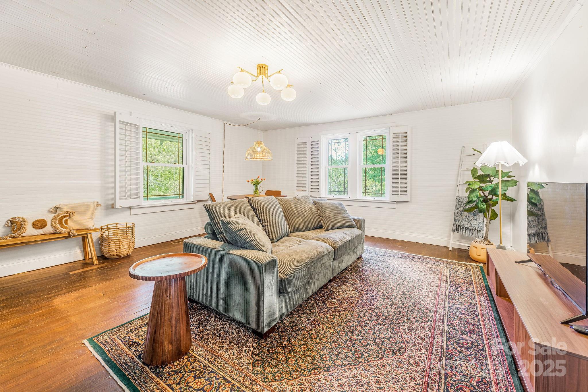 71 Persimmon Lane Canton, NC 28716 - Photo 10 of 25 a living room with furniture and a large window