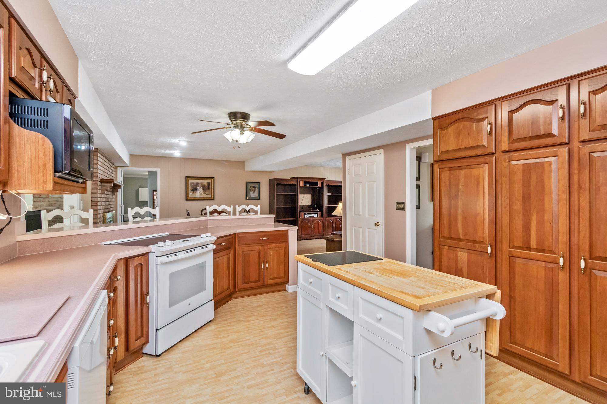 529 Beards Hill Road Aberdeen, MD 21001 - Photo 24 of 65 a kitchen with stainless steel appliances granite countertop a refrigerator a stove and a sink with wooden floor