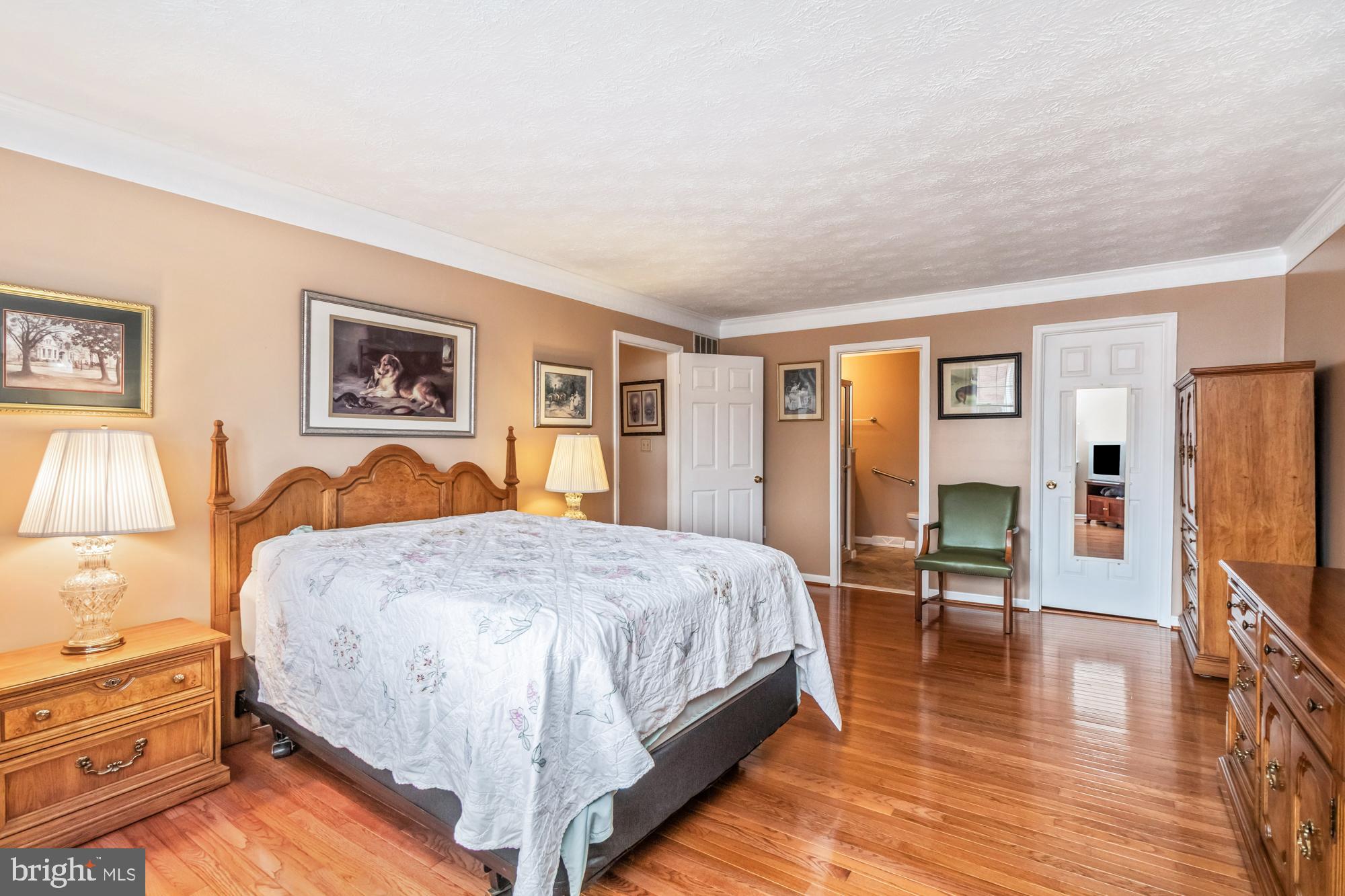 529 Beards Hill Road Aberdeen, MD 21001 - Photo 35 of 65 a spacious bedroom with a bed a dresser and chair