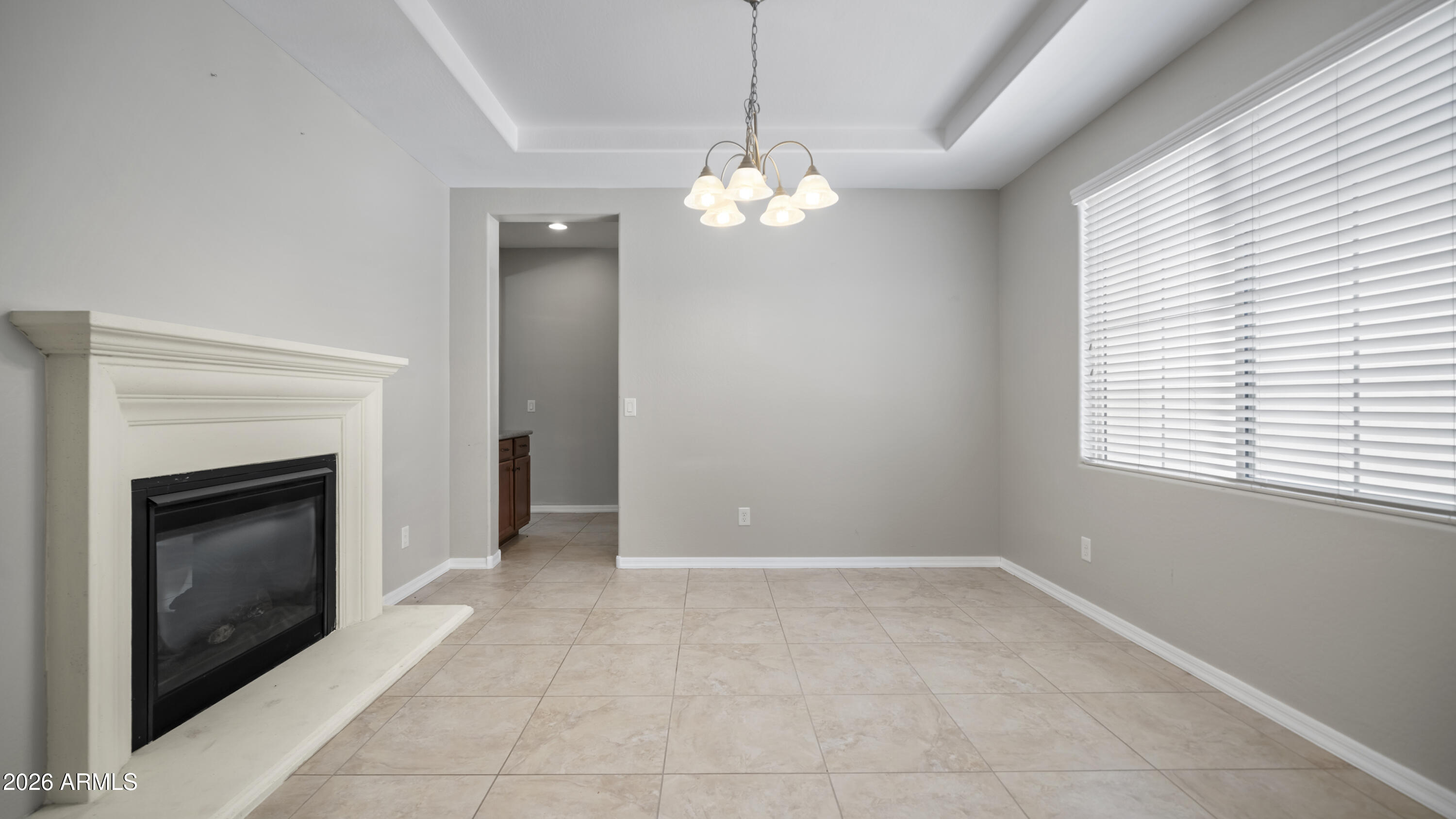 16159 West Granada Road Goodyear, AZ 85395 - Photo 6 of 41 a view of an empty room with a fireplace and a window