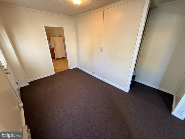 a kitchen with a refrigerator sink stove and a granite counter top