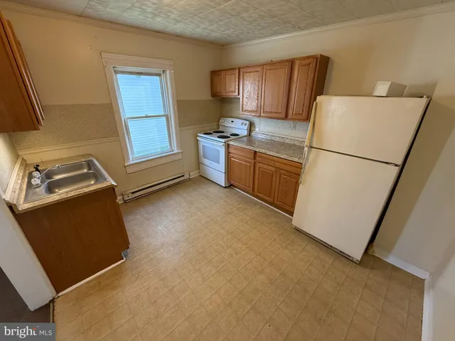 an entryway in a livingroom with wooden floor