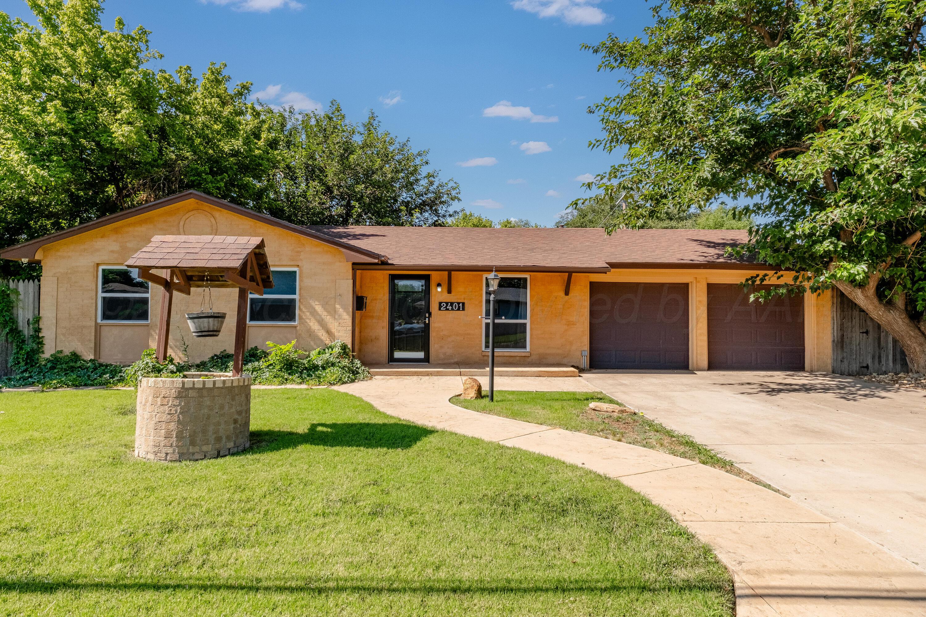 2401 Darrell Avenue Amarillo, TX 79110 - Photo 1 of 35 a front view of a house with a yard and garage