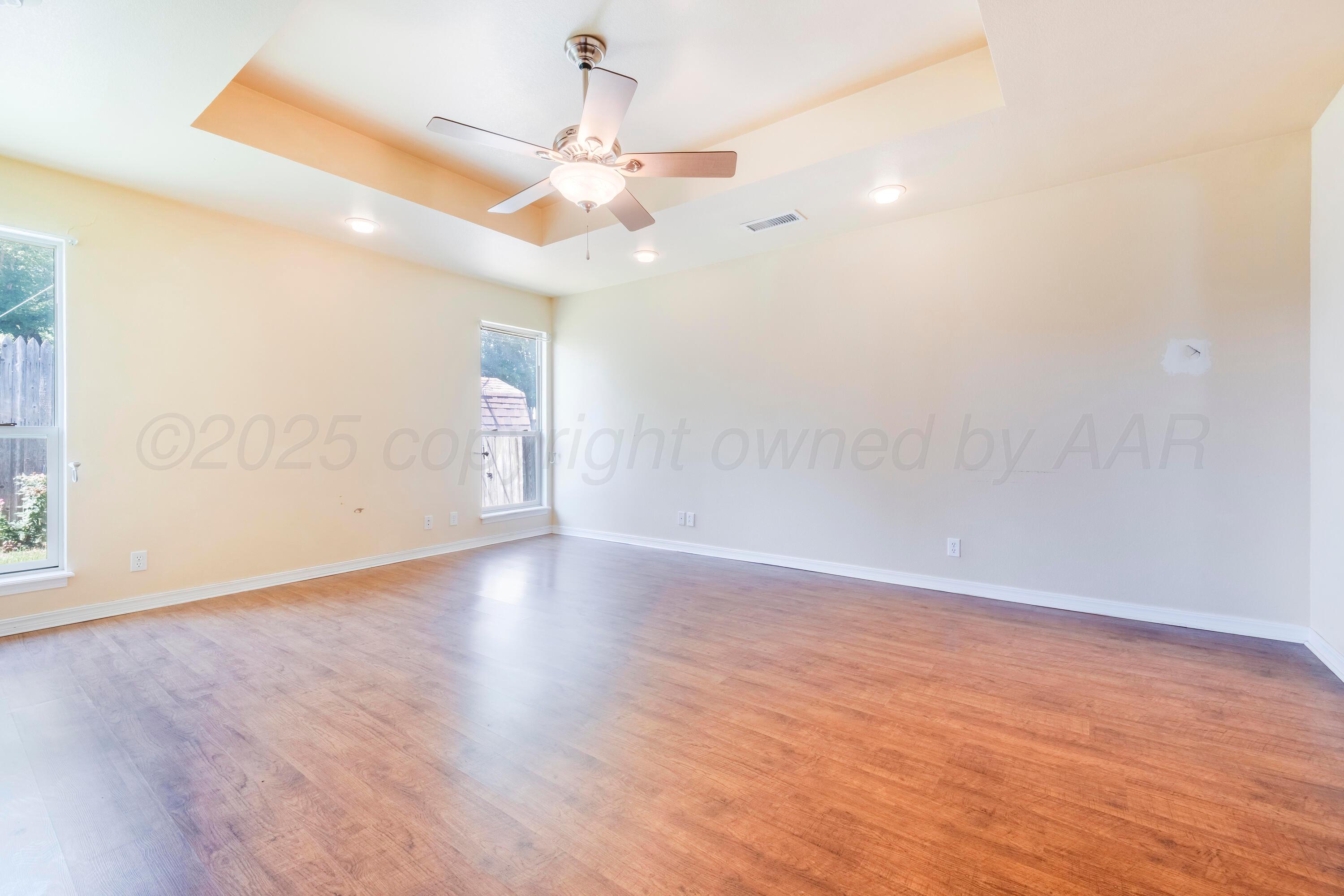 2401 Darrell Avenue Amarillo, TX 79110 - Photo 12 of 35 an empty room with wooden floor fan and window