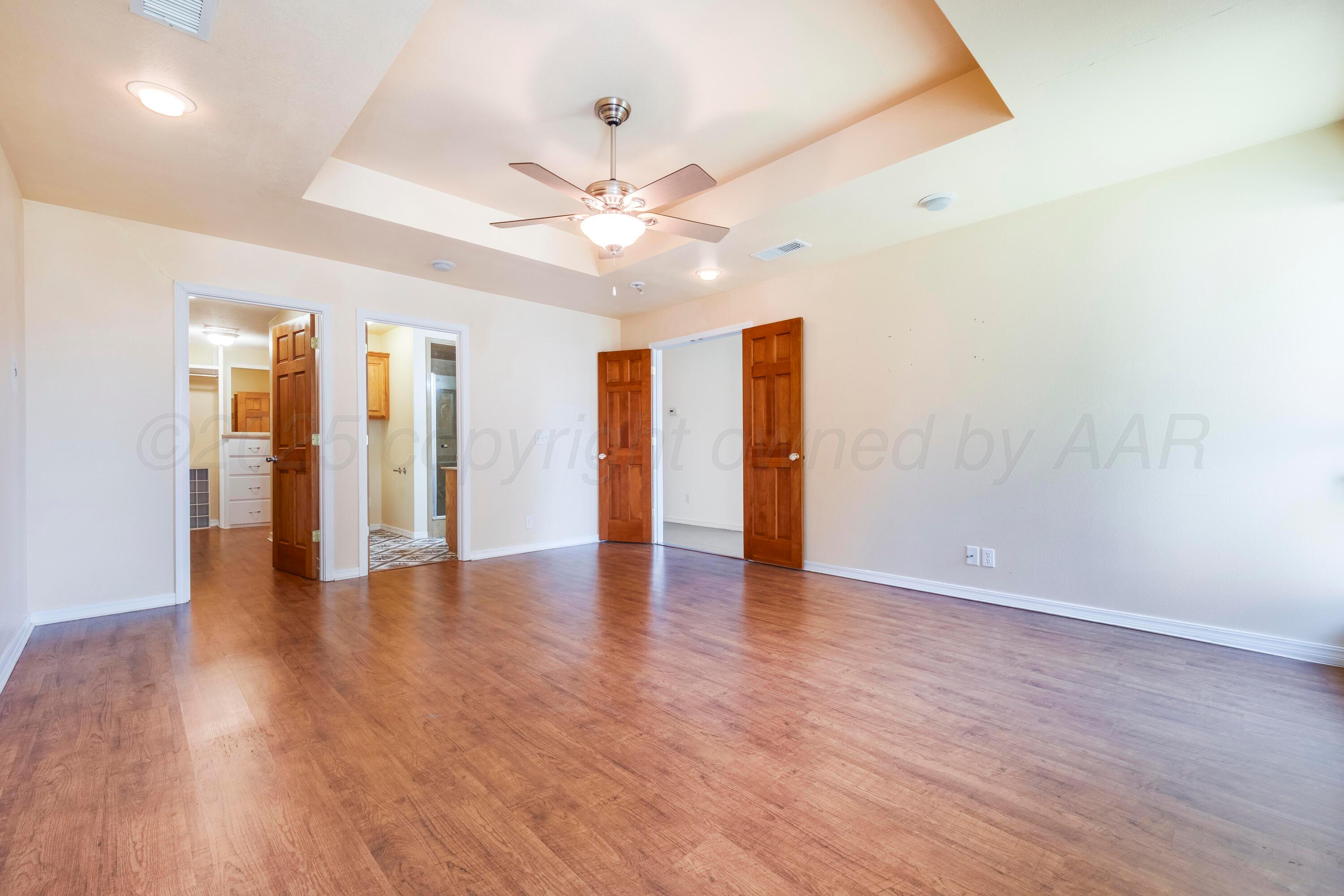 2401 Darrell Avenue Amarillo, TX 79110 - Photo 13 of 35 a view of an empty room with window and wooden floor