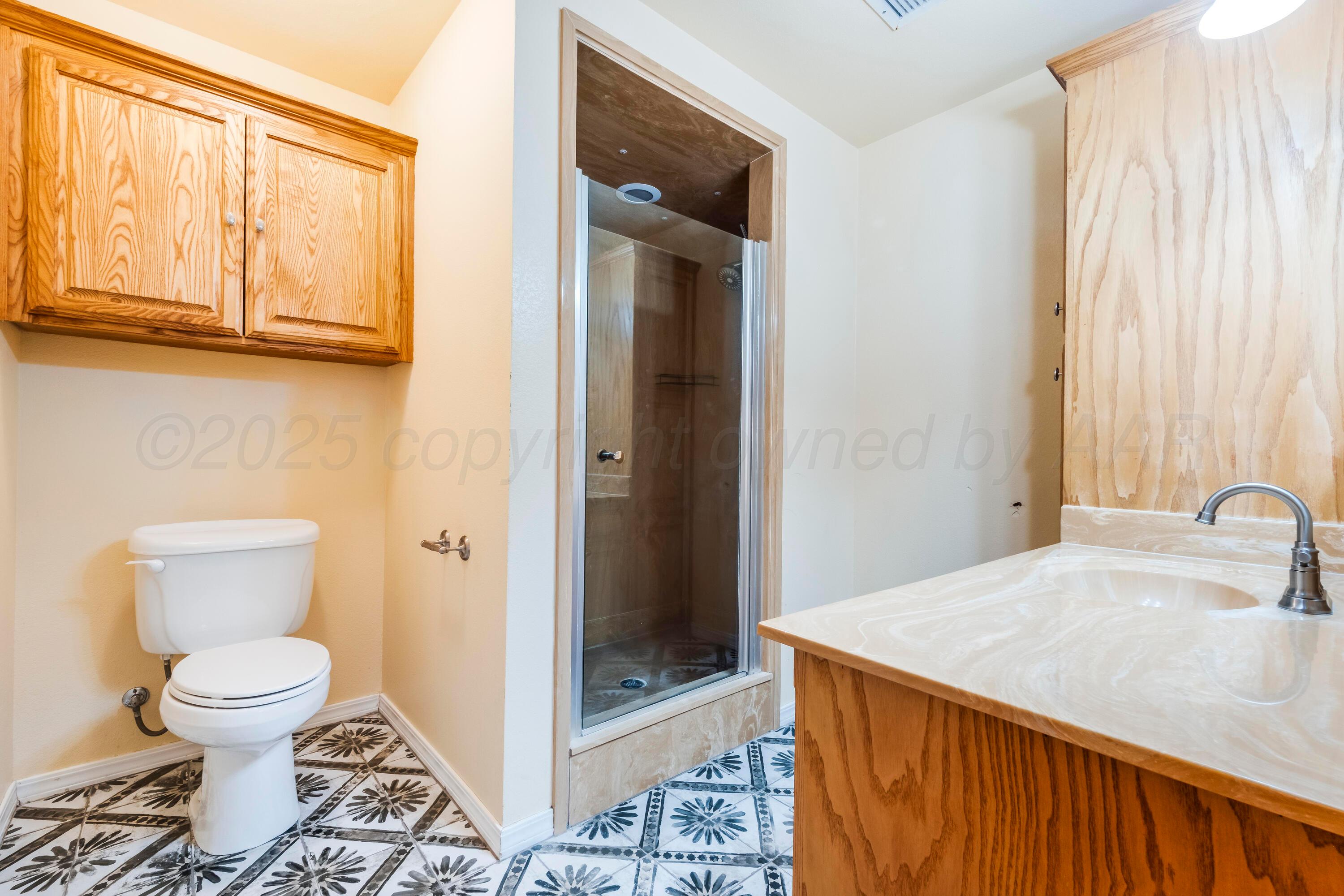 2401 Darrell Avenue Amarillo, TX 79110 - Photo 14 of 35 a bathroom with a toilet sink and shower