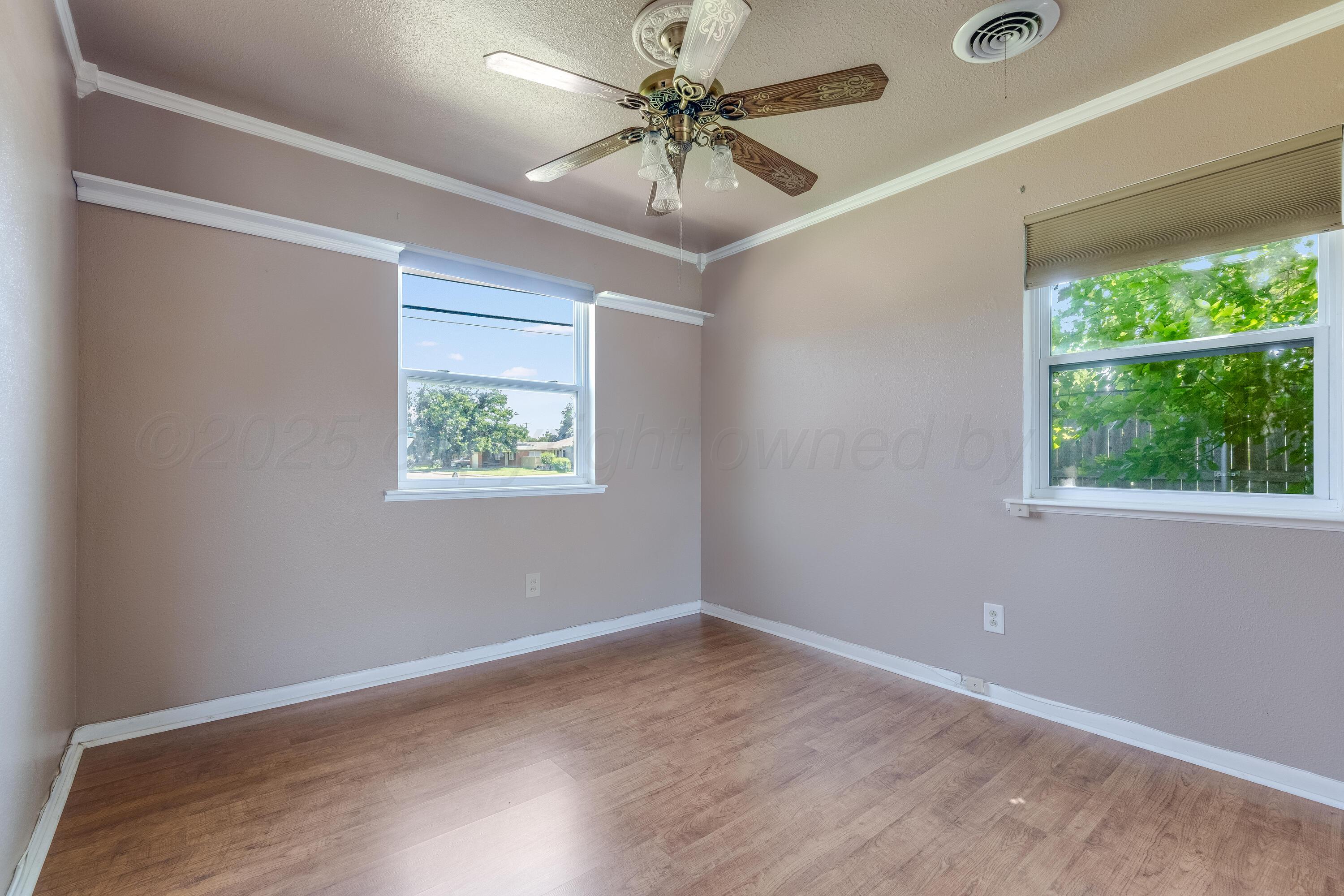 2401 Darrell Avenue Amarillo, TX 79110 - Photo 19 of 35 an empty room with a window and a ceiling fan