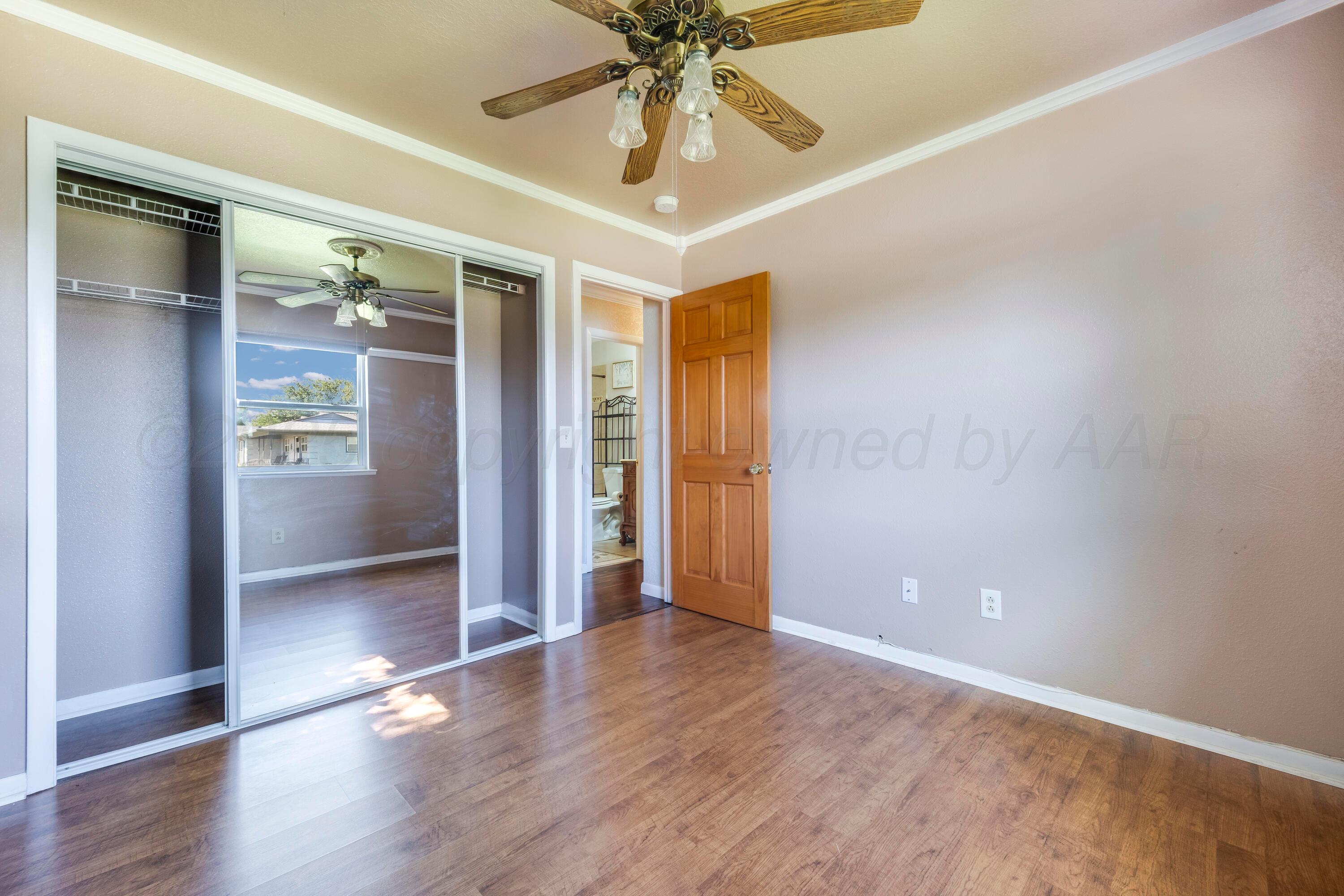 2401 Darrell Avenue Amarillo, TX 79110 - Photo 20 of 35 an empty room with wooden floor and entryway