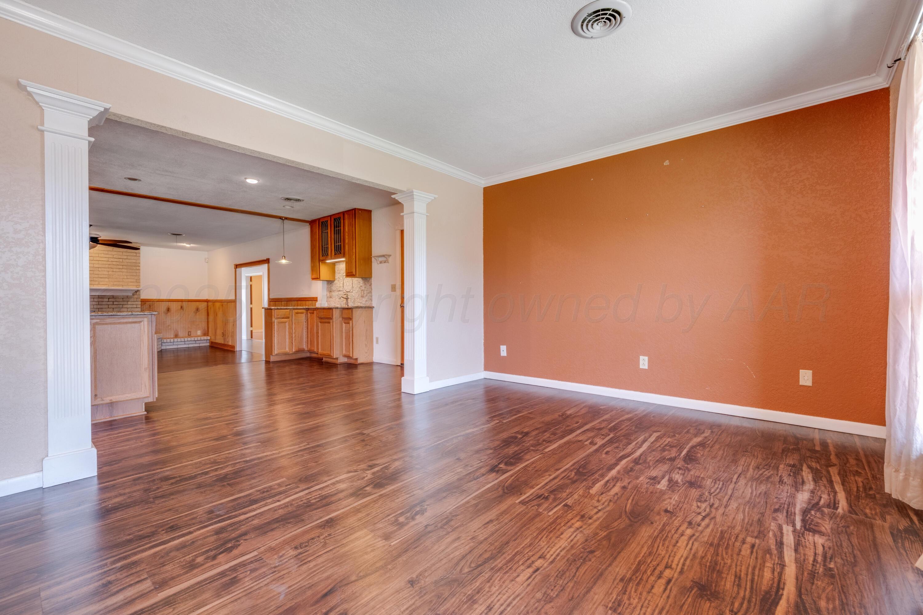 2401 Darrell Avenue Amarillo, TX 79110 - Photo 2 of 35 a view of empty room with wooden floor and windows