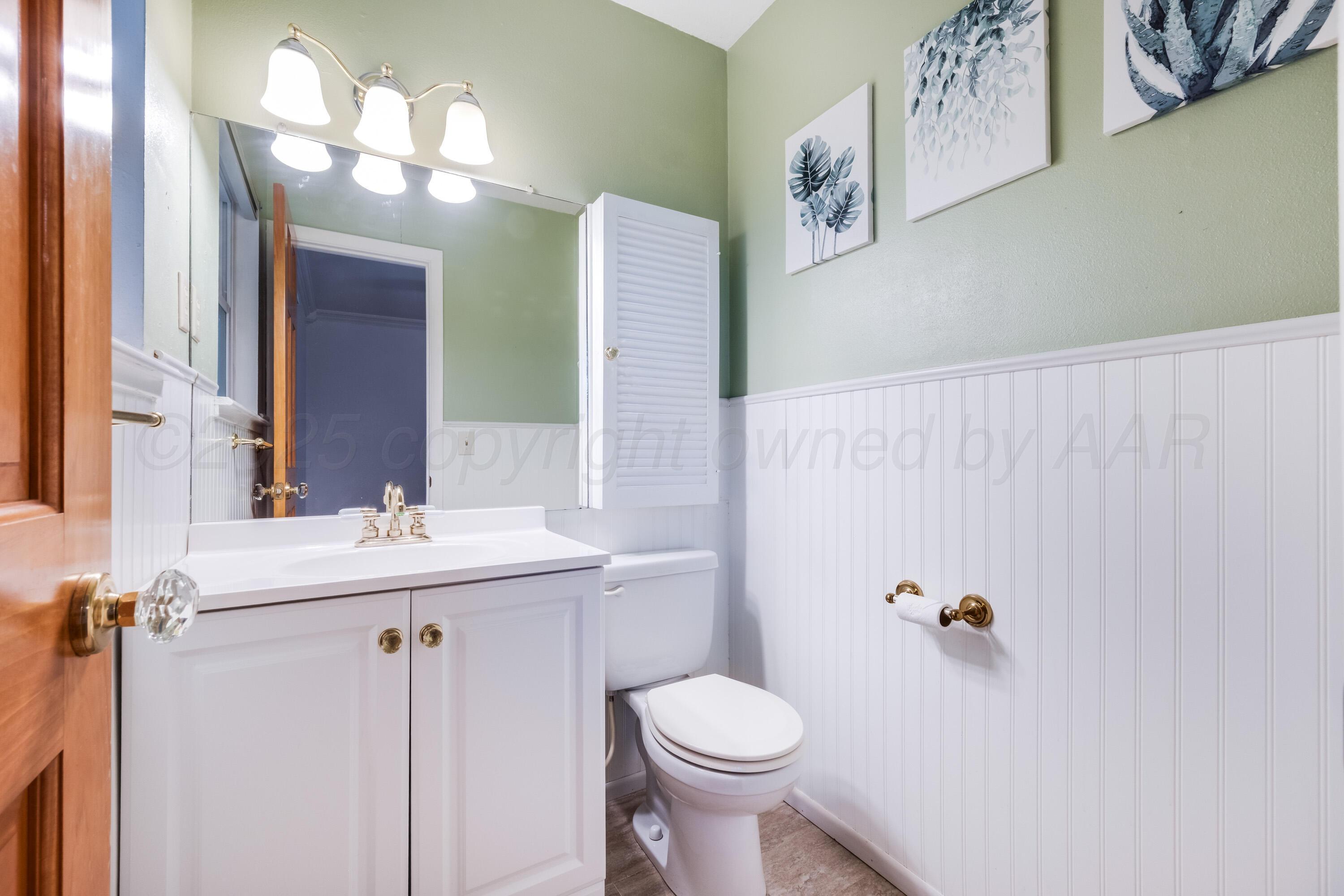 2401 Darrell Avenue Amarillo, TX 79110 - Photo 23 of 35 a bathroom with a sink toilet and a mirror