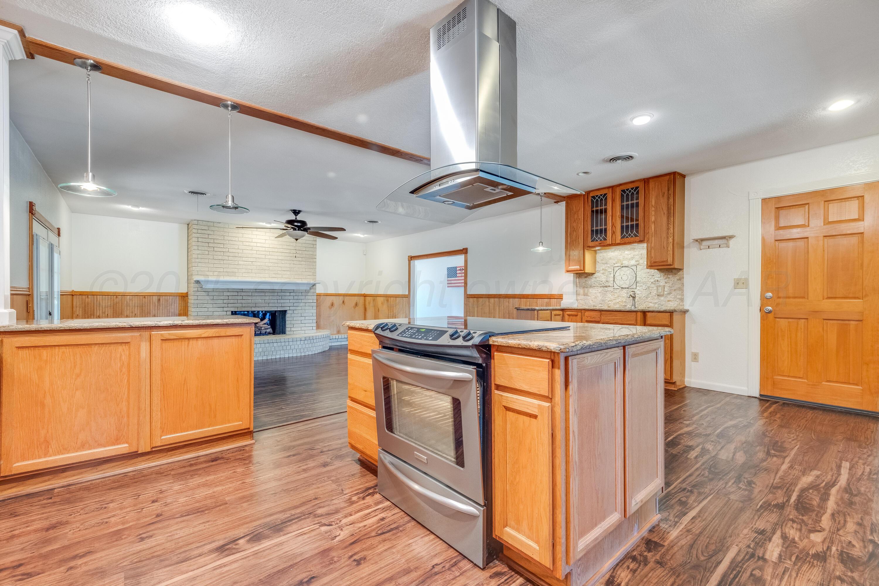 2401 Darrell Avenue Amarillo, TX 79110 - Photo 8 of 35 a kitchen with stainless steel appliances granite countertop a stove and a refrigerator