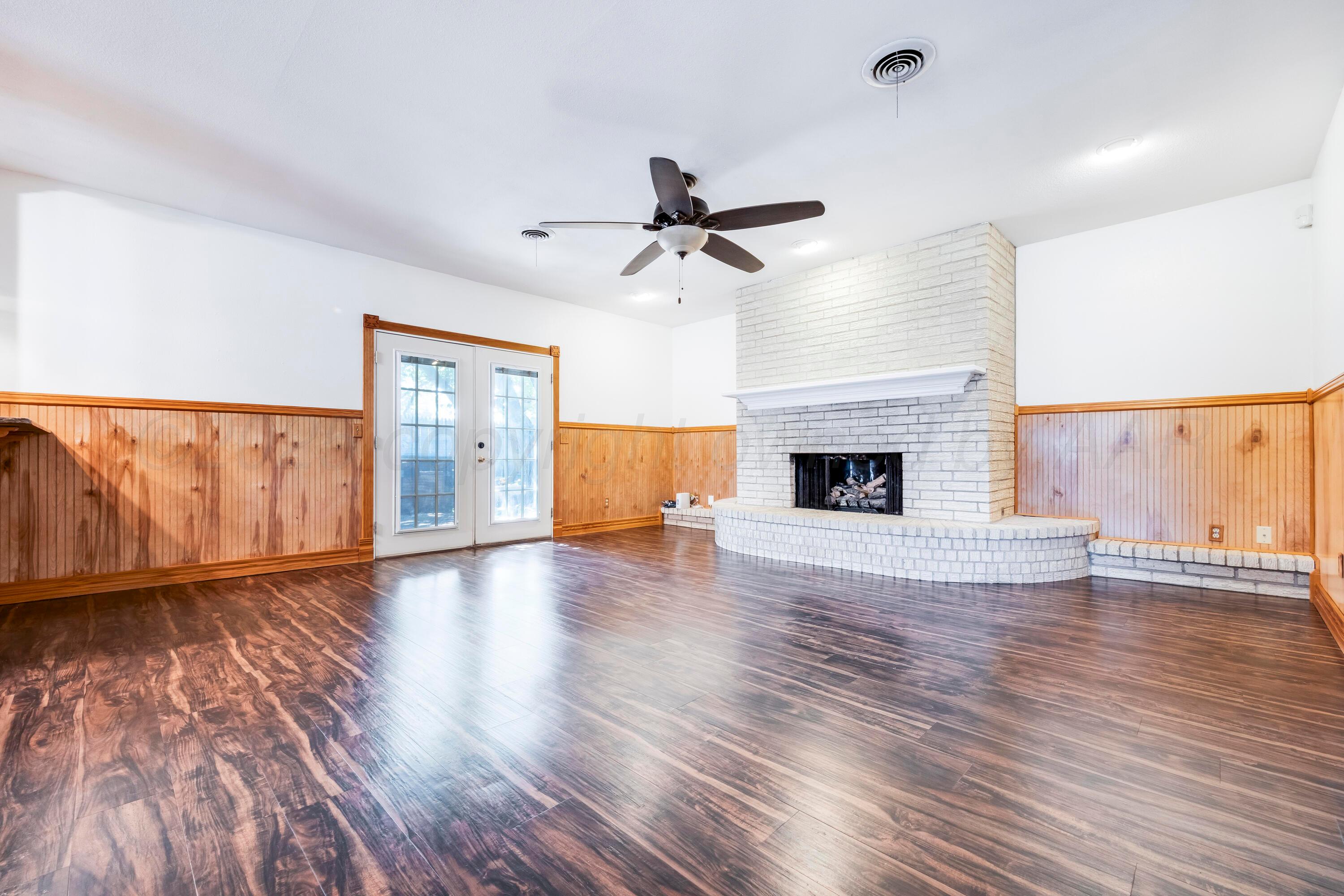 2401 Darrell Avenue Amarillo, TX 79110 - Photo 10 of 35 a view of a livingroom with wooden floor and a fireplace