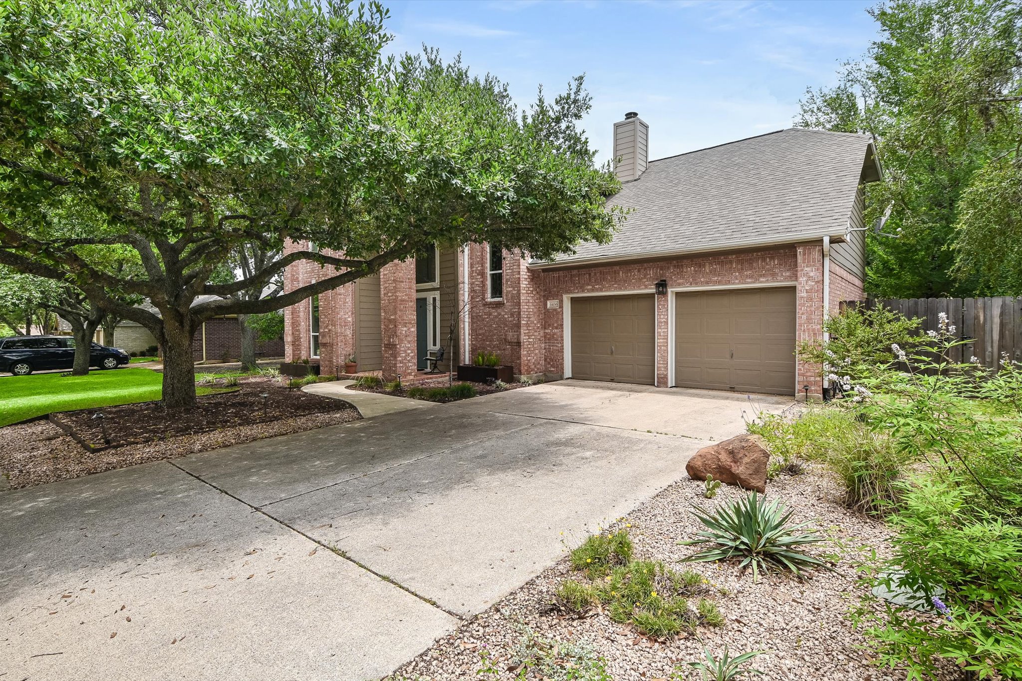 6456 Ruxton Lane Austin, TX 78749 - Photo 2 of 30 Brick facade with an inviting entryway, a broad driveway, and lush landscaping create appealing curb appeal.