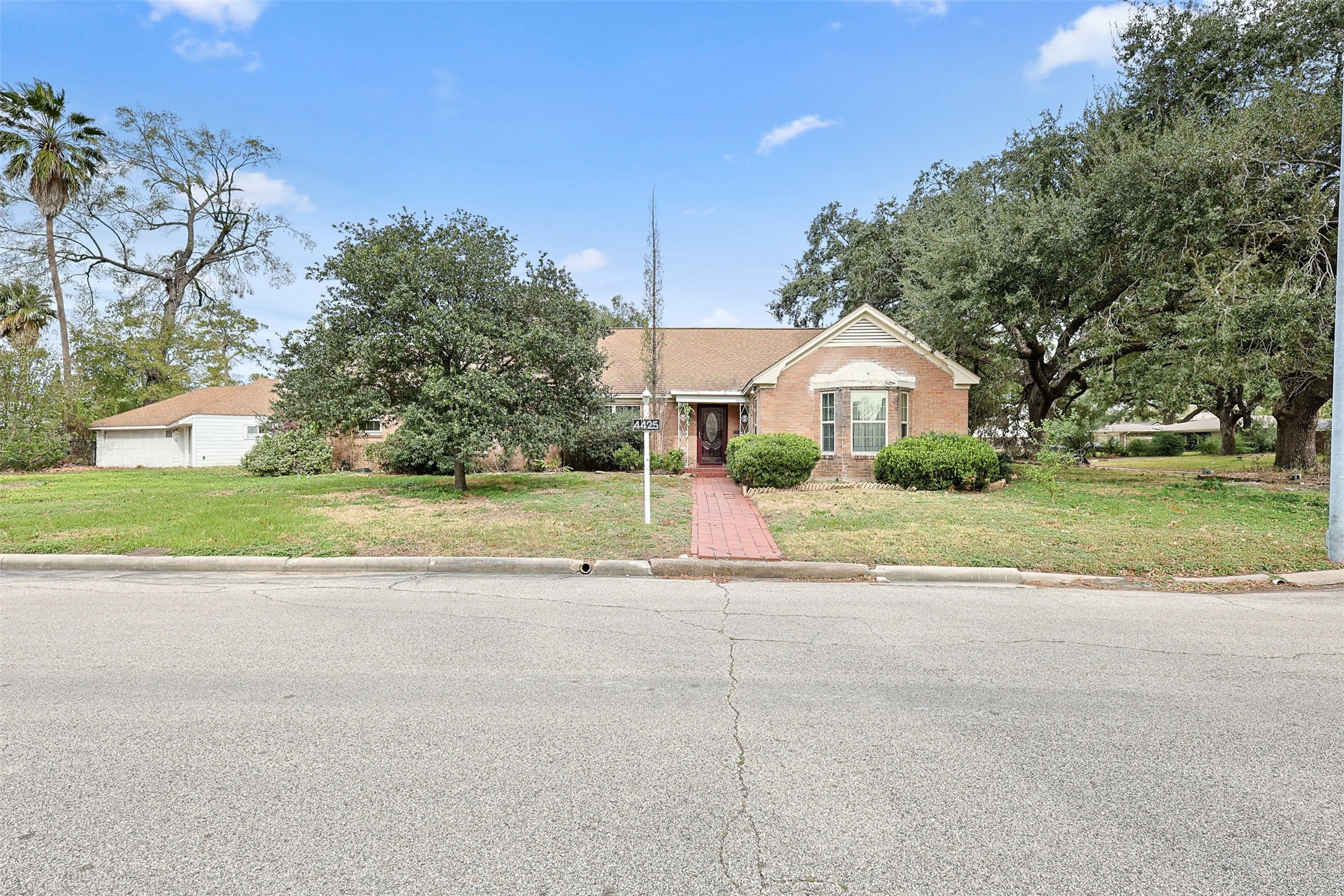 a front view of house with yard and green space