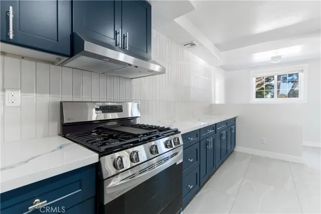 a kitchen with stainless steel appliances granite countertop a stove and a cabinets