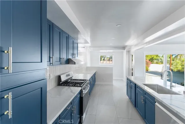 a kitchen with a stove sink and cabinets