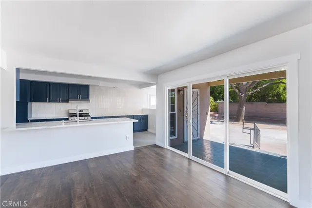 a view of a kitchen with a sink and a large window