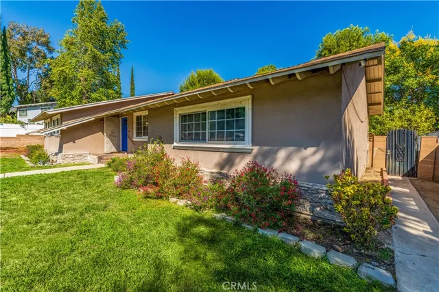 a front view of house with yard and trees