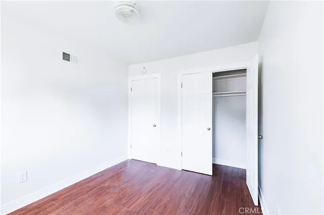 a view of a room with wooden floor