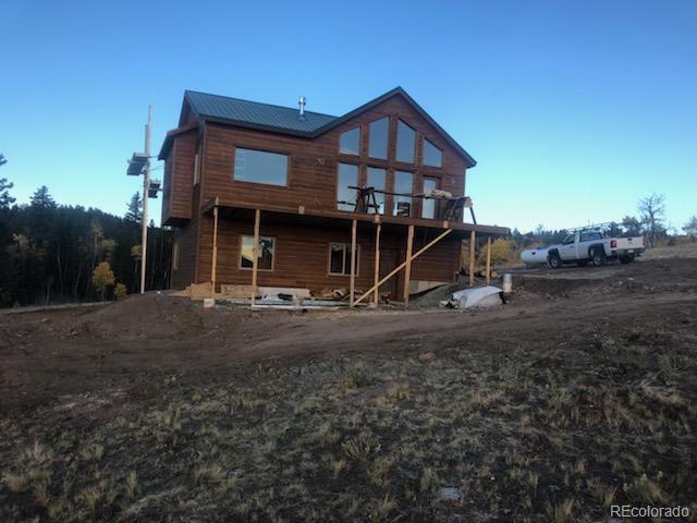 6122 Remington Road Como, CO 80432 - Photo 1 of 5 a view of a house with a yard
