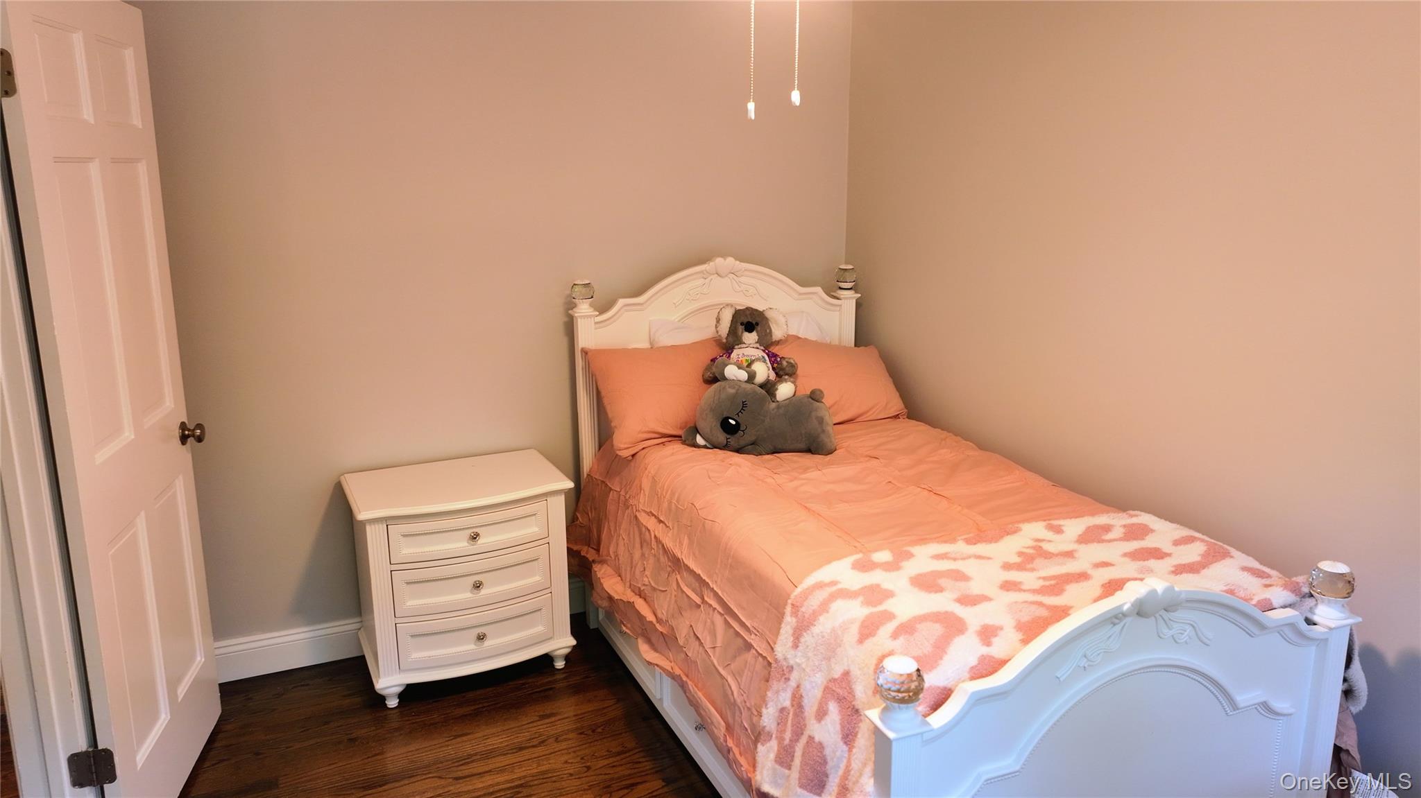 522 Moriches Road St. James, NY 11780 - Photo 26 of 49 a bedroom with a bed and wooden floor