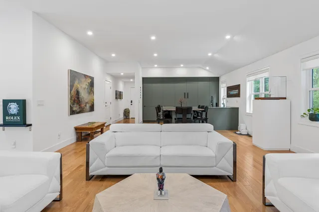 a living room with furniture and a chandelier